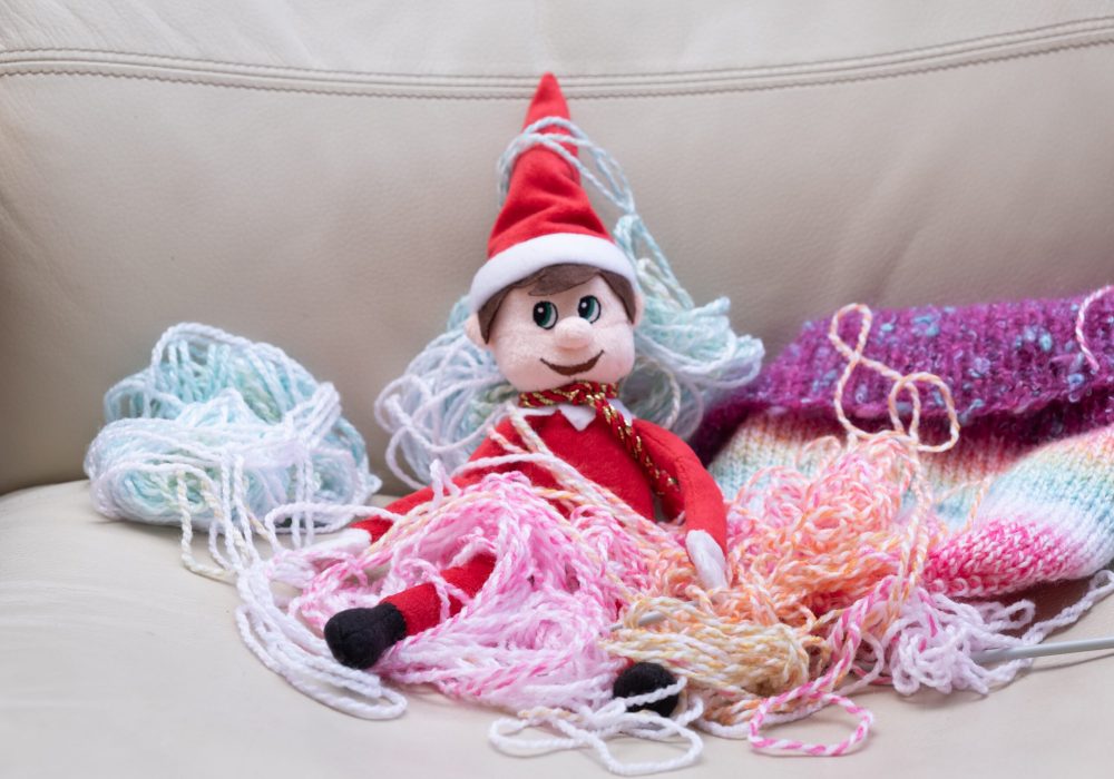 Christmas,Elf,Mischief,,Naughty,Elf,Makes,Mess,With,Knitting,Wool.